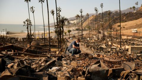 Kevin Marshall sifts through his mother's fire-ravaged property in the the Palisades Fire in the Pacific Palisades neighborhood of Los Angeles, Saturday, Jan. 11, 2025. (AP Photo/John Locher)