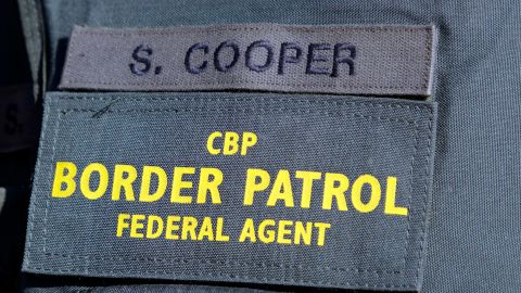 In this photo taken Thursday, Oct. 6, 2011, Senior Border Patrol Agent Sheldon Cooper's name is shown on his uniform at the International Railroad Bridge in Buffalo, N.Y. (AP Photo/David Duprey)