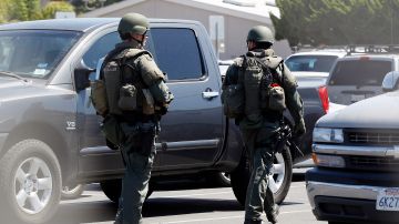 Police search the parking lot after a missing Navy medic left a note claiming he planed explosives in the school at San Clemente High School in San Clemente, Wednesday, Sept. 7, 2011.  Bomb squads did not find any explosives on an initial sweep but are continuing to search the large campus. A search was launched for the missing medic, but officials do not believe any military-grade explosive was stolen from the base, said Marine Lt. Joshua Benson. (AP Photo Lori Shepler)