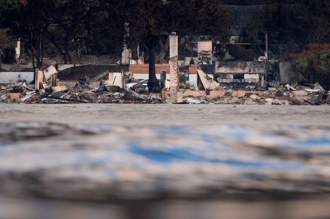 Properties damaged by the Palisades Fire are seen from a coastline perspective Friday, Jan. 17, 2025 in Malibu, Calif. (AP Photo/Carolyn Kaster)