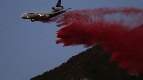 An air tanker drops retardant while battling the Eaton Fire on Monday, Jan. 13, 2025, in Altadena, Calif. (AP Photo/Ty ONeil)