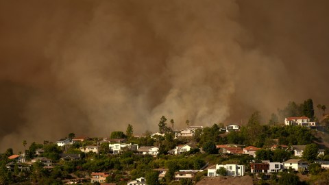 Smoke from the Palisades Fire rises over residences in Mandeville Canyon Saturday, Jan. 11, 2025, in Los Angeles. (AP Photo/Jae C. Hong)