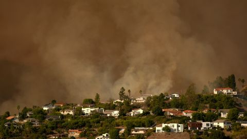 Smoke from the Palisades Fire rises over residences in Mandeville Canyon Saturday, Jan. 11, 2025, in Los Angeles. (AP Photo/Jae C. Hong)