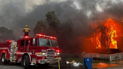 Firefighters battle the Palisades Fire as it burns structures in the Pacific Palisades neighborhood of Los Angeles, Wednesday, Jan. 8, 2025. (AP Photo/Eugene Garcia)