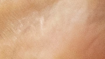 FILE - Dr. Sydney Sewall fills a syringe with the COVID-19 vaccine at the Augusta Armory, Dec. 21, 2021, in Augusta, Maine. (AP Photo/Robert F. Bukaty, File)