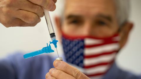 FILE - Dr. Sydney Sewall fills a syringe with the COVID-19 vaccine at the Augusta Armory, Dec. 21, 2021, in Augusta, Maine. (AP Photo/Robert F. Bukaty, File)