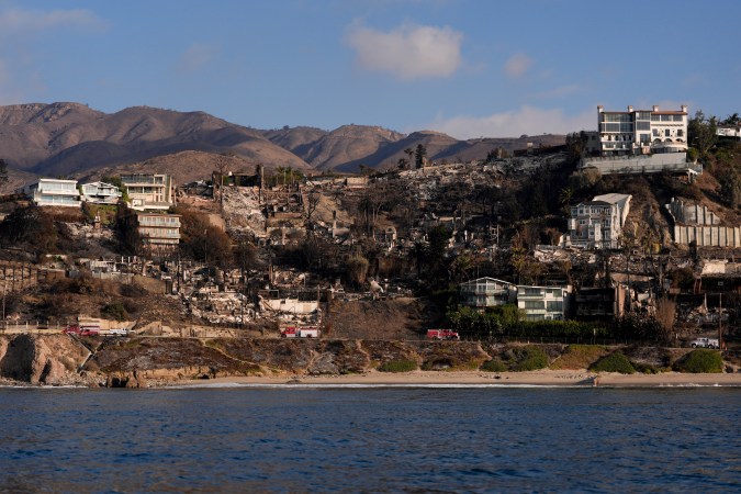Properties damaged by the Palisades Fire are seen from a coastline perspective in the Pacific Palisades neighborhood of Los Angeles, Friday, Jan. 17, 2025. (AP Photo/Carolyn Kaster)