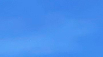A large plume of smoke caused by the Hughes Fire rises from Castaic Lake as seen from a neighborhood of Santa Clarita, Calif., Wednesday, Jan. 22, 2025. (AP Photo/Marcio Jose Sanchez)