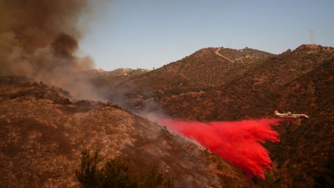 Retardant is dropped by air tanker on the Palisades Fire in Mandeville Canyon Saturday, Jan. 11, 2025, in Los Angeles. (AP Photo/Eric Thayer)