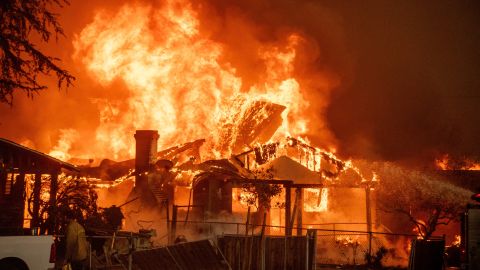 The Eaton Fire burns a structure Wednesday, Jan. 8, 2025 in Altadena, Calif. (AP Photo/Ethan Swope)