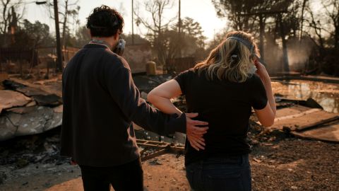 Homeowners Sohrab Nafici, left, and Christine Meinders return to their fire-ravaged neighborhood in the aftermath of the Eaton Fire on Friday, Jan. 10, 2025, in Altadena, Calif. (AP Photo/Jae C. Hong)