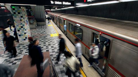 Commuters enter and exit a train at the MTA Red Line Hollywood/Western station in Los Angeles Wednesday, April 25, 2012.[After more than 20 years of using what amounted to an honor system on the region's light rail system, the board of Los Angeles County's Metropolitan Transportation Authority is expected to vote Thursday to begin locking the gates at its stations. (AP Photo/Reed Saxon)