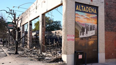 A wall mural depicting Altadena stands next to the destroyed Altadena Hardware store after the Eaton Fire, Tuesday, Jan. 14, 2025, in Altadena, Calif. (AP Photo/Chris Pizzello)
