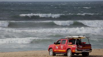 A Los Angeles County Lifeguard patrols the beach as winds whip up whitecaps and rough surf in Santa Monica Bay off El Segundo, Calif., Sunday, Nov. 27, 2016. The National Weather Service is warning travelers about heavy winds and potential blowing snow on busy Interstate 5 in Southern California. (AP Photo/John Antczak)