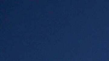 Rene Amy, left, and Sean Courtney pack up their stuff after hanging an "Altadena Strong" sign Wednesday, Jan. 15, 2025, in Altadena, Calif. (AP Photo/John Locher)