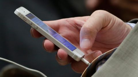 FILE - In this Aug. 11, 2014 file photo, State Sen. Anthony Canella, R-Ceres, uses his smartphone at the Capitol in Sacramento, Calif. California Gov. Jerry Brown on Thursday, Oct. 8, 2015 signed into law the California Electronic Communications Privacy Act, a law which requires police to get a court order before they can search messages, photos and other digital data stored on phones or company servers. (AP Photo/Rich Pedroncelli, File)