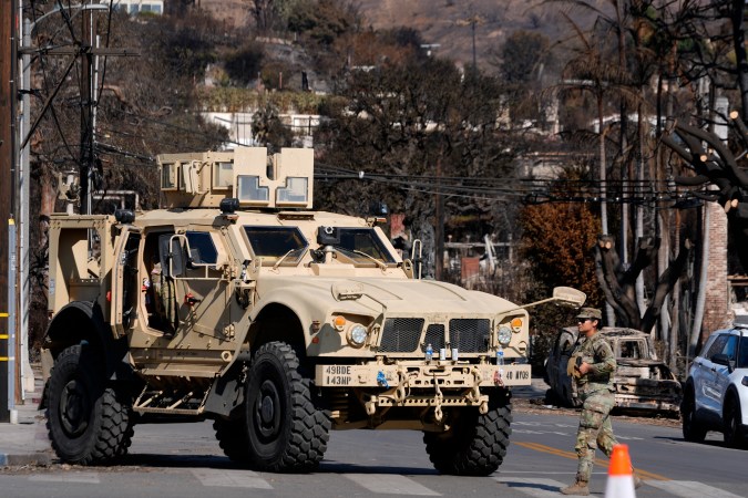 A National Guard soldier blocks a street in the Pacific Palisades in the neighborhood of Los Angeles in the aftermath of the Palisades Fire on Friday. Jan. 17, 2025. (AP Photo/Richard Vogel)