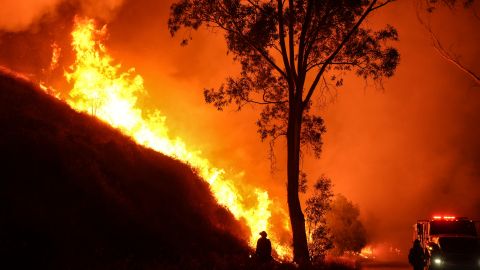 A firefighter with a drip torch watches the Hughes Fire burning along a hillside in Castaic, Calif., Wednesday, Jan. 22, 2025. (AP Photo/Jae C. Hong)