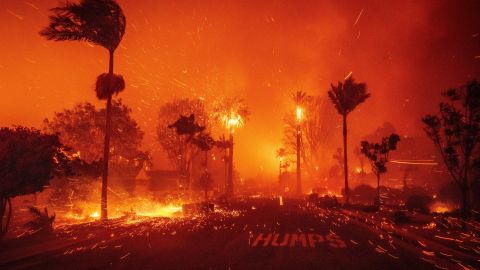 The Palisades Fire ravages a neighborhood amid high winds in the Pacific Palisades neighborhood of Los Angeles, Tuesday, Jan. 7, 2025. (AP Photo/Ethan Swope)