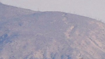 Properties damaged by the Palisades Fire are seen from a coastline perspective in the Pacific Palisades neighborhood of Los Angeles, Friday, Jan. 17, 2025. (AP Photo/Carolyn Kaster)