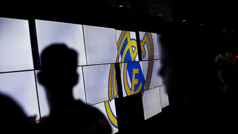 In this picture taken on May 18, 2014, Real Madrid's supporters are backlit by screens displaying the Real Madrid team emblem on the trophies gallery of the Santiago Bernabeu stadium in Madrid. Real Madrid and Atletico Madrid will play in the Champions League final on Saturday in Lisbon, Portugal. (AP Photo/Daniel Ochoa de Olza)