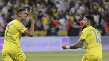 Al-Nassr's Cristiano Ronaldo, and Alex Telles, right, celebrate a goal against Al-Hilal during the Arab Club Champions Cup at King Fahd Stadium in Taif, Saudi Arabia, Saturday, Aug. 12, 2023. (AP Photo/Samah Zidan)