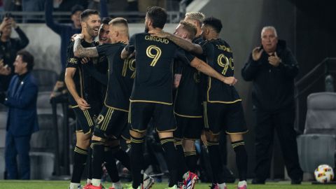 Los Angeles FC players celebrate a goal by midfielder Ryan Hollingshead (24) during the second half of an MLS Western Conference semifinal soccer match against the Seattle Sounders in Los Angeles, Saturday, Nov. 23, 2024. (AP Photo/Kyusung Gong)