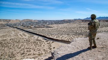 An Army soldier looks at the border wall while providing security to the visit of Defense Secretary Pete Hegseth to the US-Mexico border in Sunland Park, N.M., Monday, Feb. 3, 2025. (AP Photo/Andres Leighton)