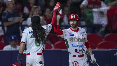 Mexico's Billy Hamilton, left, celebrates with Michael Wielansky after he scoring against Puerto Rico during a Caribbean Series baseball semifinal game at Nido de los Aguilas stadium in Mexicali, Mexico, Wednesday, Feb. 5, 2025. (AP Photo/Fernando Llano)