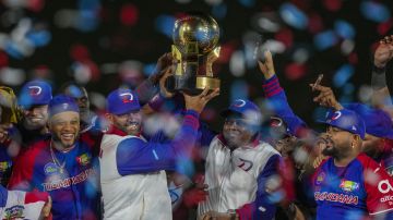 Players of Dominican Republic hold up the trophy after winning the Caribbean Series baseball final game against Mexico at Nido de los Aguilas stadium in Mexicali, Mexico, Friday, Feb. 7, 2025. (AP Photo/Fernando Llano)