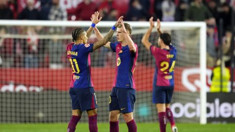 Barcelona's Raphinha, left, and Dani Olmo celebrate at the end of a Spanish La Liga soccer match between Sevilla and FC Barcelona at the Ramon Sanchez Pizjuan stadium in Seville, Spain, Sunday, Feb. 9, 2025. (AP Photo/Jose Breton)