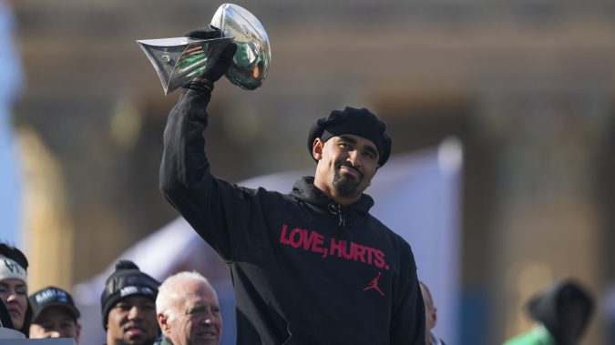 Philadelphia Eagles quarterback Jalen Hurts holds up the Lombardi trophy as he speaks during the team's NFL football Super Bowl 59 parade and celebration, Friday, Feb. 14, 2025, in Philadelphia. (AP Photo/Matt Rourke)