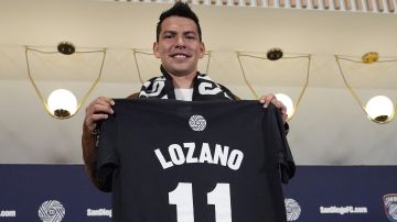 FILE - Hirving "Chucky" Lozano poses with his new San Diego FC jersey during an introductory news conference for the new MLS soccer team Thursday, June 13, 2024, in San Diego. (AP Photo/Gregory Bull, File)