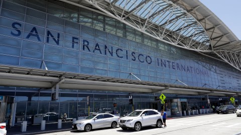 FILE - Vehicles wait outside the international terminal at San Francisco International Airport in San Francisco on July 11, 2017. A worker at the airport was stabbed Tuesday, July 19, 2022, and a suspect was in custody, police said. It is the latest in a series of security incidents at the airport south of San Francisco. (AP Photo/Marcio Jose Sanchez, File)