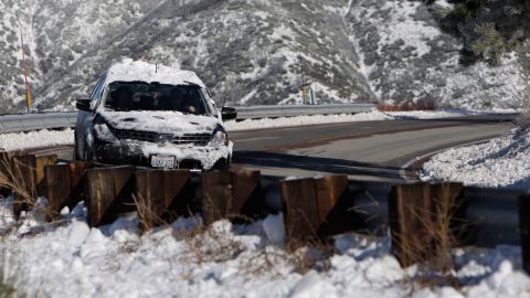 A snow-covered vehicle drives along Highway 330 near Big Bear Lake, Calif., Tuesday, Dec. 8, 2009. (AP Photo/Jae C. Hong)