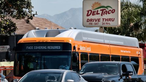 A Los Angeles Metro bus with an electronic display requiring a face mask is seen as makes it's way through traffic in the Panorama City, section of Los Angeles on Tuesday, April 19, 2022. A federal judge's decision to strike down a national mask mandate was met with cheers on some airplanes but also concern about whether it's really time to end the order sparked by the COVID-19 pandemic. (AP Photo/Richard Vogel)