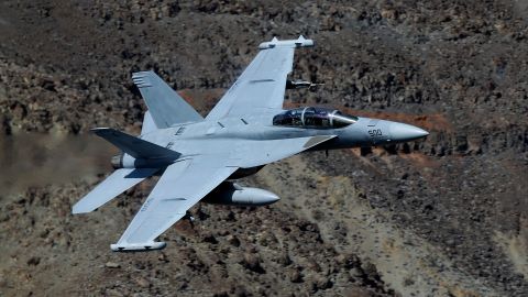 In this Feb. 27, 2017, photo, an EA-18G Growler from China Lake VX-9 Vampire squadron flies through the nicknamed Star Wars Canyon in Death Valley National Park, Calif. Military jets roaring over national parks have long drawn complaints from hikers and campers. But in California's Death Valley, the low-flying combat aircraft skillfully zipping between the craggy landscape has become a popular attraction in the 3.3 million acre park in the Mojave Desert, 260 miles east of Los Angeles. (AP Photo/Ben Margot)