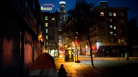 Sitting in front of a tent pitched on a sidewalk, Daniel Shawn, a 48-year-old homeless man, is silhouetted against the street lights Wednesday, Sept. 6, 2017, in downtown Los Angeles. Since last fall, Los Angeles city and county voters approved spending $4.7 billion in an attempt to tackle the problem, largely through adding low-cost housing. (AP Photo/Jae C. Hong)