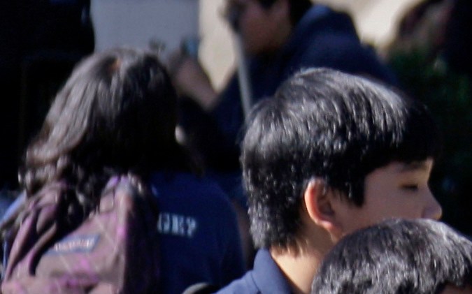 Teacher Colleen Schwab talks with students on the campus of Woodland Hills Academy, a charter middle school in the Woodland Hills area of Los Angeles on Oct. 26, 2010. Independent charter schools run by teacher groups have been around for several decades, but a new teacher-led model is emerging on a wider scale that gives teachers more power and schools more autonomy. Some, like Woodland Hills, retain principals but reduce their authority; some eschew principals altogether. (AP Photo/Reed Saxon)