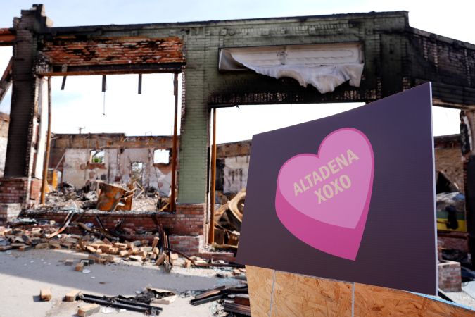 A sign is pictured outside a property destroyed by the Eaton Fire, Monday, Feb. 17, 2025, in Altadena, Calif. (AP Photo/Chris Pizzello)