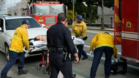 An unidentified high school student is assisted by paramedics after a fist fight broke among students at a rally to stop President Trump's mass deportations and demand immigration reform in downtown Los Angeles on Friday, Feb. 7, 2025. (AP Photo/Damian Dovarganes)