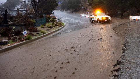 Mud flows down a road in the Eaton Fire zone during a storm Thursday, Feb. 13, 2025, in Altadena, Calif. (AP Photo/Etienne Laurent)