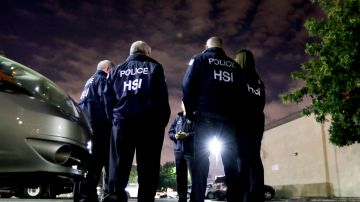 FILE - In this Jan. 10, 2018, file photo, U.S. Immigration and Customs Enforcement agents gather before serving an employment audit notice at a 7-Eleven convenience store, in Los Angeles. U.S. Immigration and Customs Enforcement is the face of President Donald Trump’s hard-line immigration policy. But agency officials say their mandate is misunderstood. Government data shows ICE is mostly targeting criminals, but also that the agency has greatly ramped up overall arrests and increased the number of people arrested solely on immigration violations. And the most frequent criminal conviction was for drunken driving. (AP Photo/Chris Carlson, File)