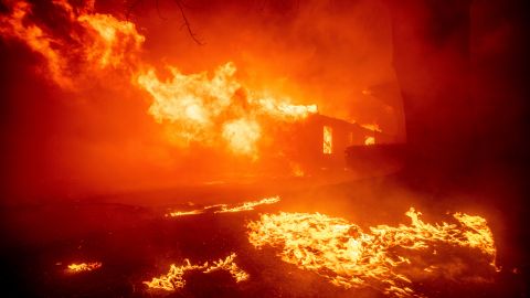 The Eaton Fire destroys a structure Tuesday, Jan. 7, 2025 in Altadena, Calif. (AP Photo/Ethan Swope)