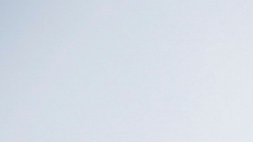 A pedestrian walks in front of the Walt Disney Concert Hall during a rain storm Wednesday, Feb. 5, 2025, in Los Angeles. (AP Photo/Damian Dovarganes)