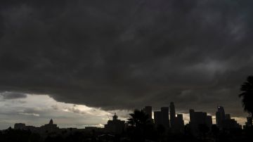 FILE - In this Saturday, Jan. 23, 2021, file photo, heavy clouds move over Los Angeles city skyline. California’s hopes for a wet “March miracle” did not materialize and a dousing of April 2021 showers may as well be a mirage at this point. The state appears in the midst of another drought only a few years after a punishing 5-year dry spell dried up rural wells, killed endangered salmon, idled farm fields and helped fuel the most deadly and destructive wildfires in modern state history. (AP Photo/Damian Dovarganes, File)