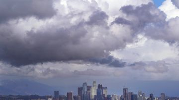 Rain clouds hover over the downtown skyline as a storm approaches Wednesday, March 10, 2021, in Los Angeles. (AP Photo/Marcio Jose Sanchez)