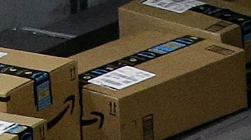 FILE - In this Feb. 9, 2018, file photo packages move down a conveyor system were they are directed to the proper shipping area at the new Amazon Fulfillment Center in Sacramento, Calif. Amazon said Monday, Sept. 14, 2020, that it will be hiring another 100,000 people to keep up with a surge of online orders. The company said the new hires will help pack, ship or sort orders, working in part-time and full-time roles. Amazon said the jobs are not related to its typical holiday hiring. (AP Photo/Rich Pedroncelli, File)