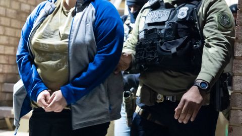 U.S. Immigration and Customs Enforcement officers detain a person, left, Monday, Jan. 27, 2025, in Silver Spring, Md. (AP Photo/Alex Brandon)