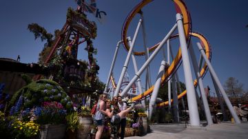 FILE - In this March 30, 2021 file photo, visitors pose for photos during the Knott's Taste of Boysenberry Festival at Knott's Berry Farm in Buena Park, Calif. California will allow indoor concerts, theater performances and other private gatherings starting April 15, 2021, as the rate of people testing positive for the coronavirus in the state nears a record low. (AP Photo/Jae C. Hong, File)